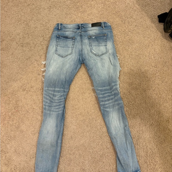 Distressed Blue Jeans with Patterned Rips - Picture 3 of 4